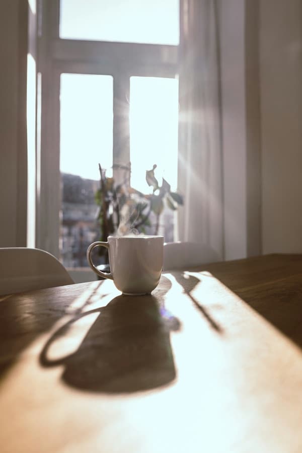 A warm mug on a table in soft morning light
